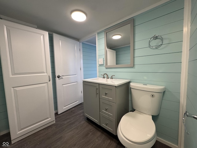 bathroom featuring vanity, toilet, and wood finished floors