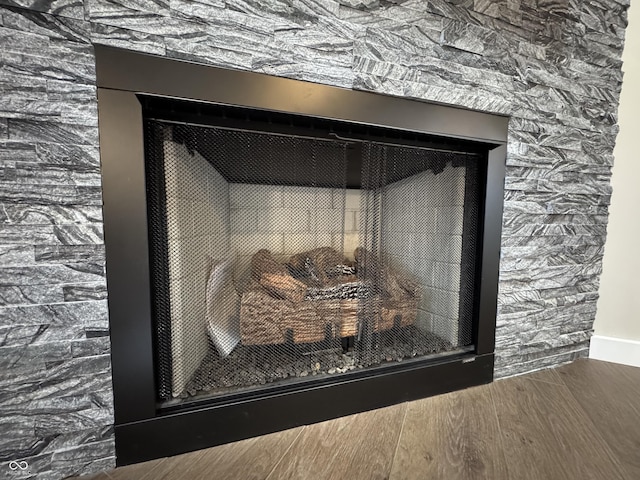 interior details featuring a fireplace and wood finished floors