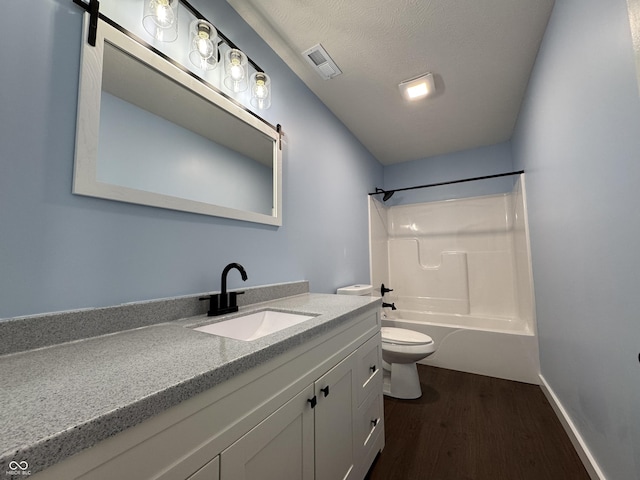 bathroom with bathtub / shower combination, toilet, wood finished floors, vanity, and visible vents