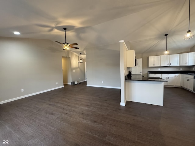 kitchen with dark countertops, open floor plan, lofted ceiling, and dark wood-style flooring