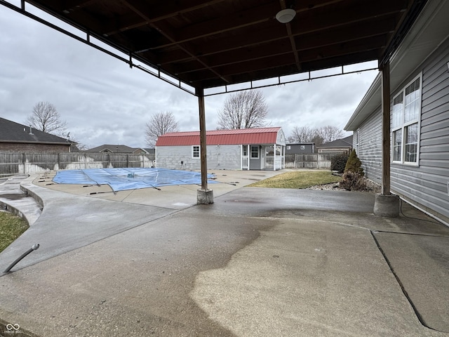 view of patio / terrace featuring a fenced backyard, a fenced in pool, and an outbuilding