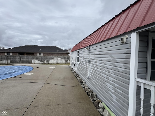 exterior space featuring a fenced in pool, a patio area, and fence