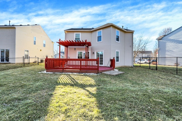 rear view of property featuring a deck, a lawn, a fenced backyard, and a pergola