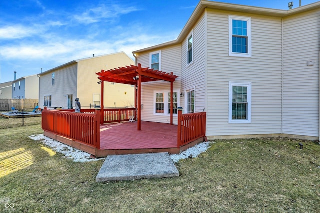 rear view of property with a yard, fence, a deck, and a pergola