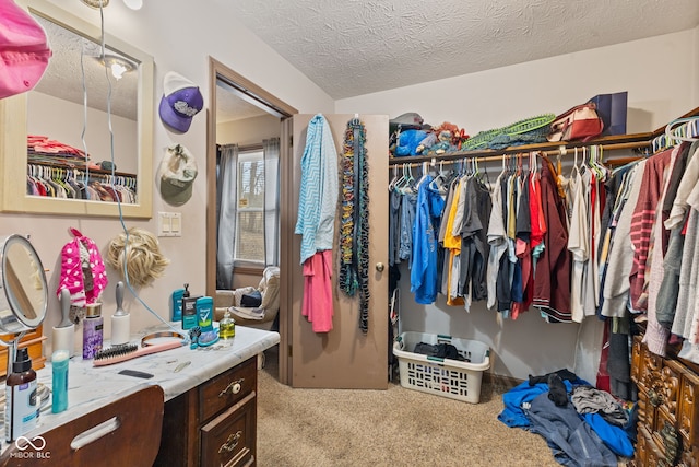 walk in closet featuring carpet flooring