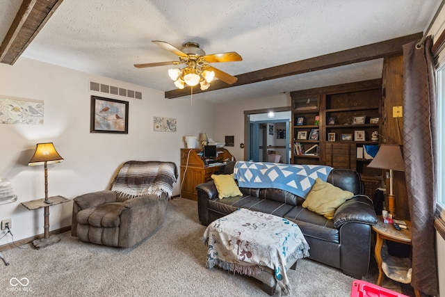 carpeted living area featuring beam ceiling, visible vents, ceiling fan, a textured ceiling, and baseboards