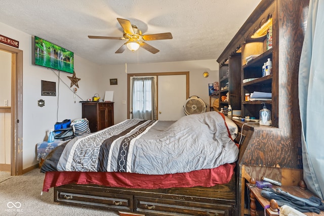 bedroom featuring carpet, ceiling fan, and a textured ceiling