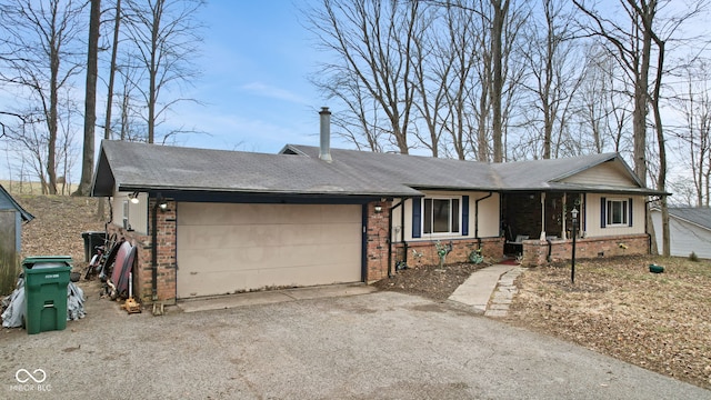 single story home with crawl space, brick siding, driveway, and an attached garage