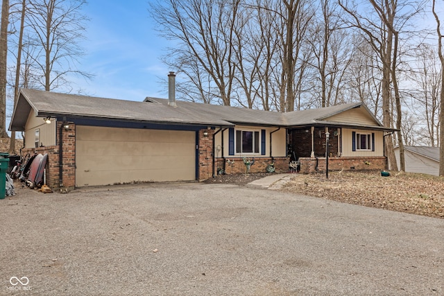 ranch-style house with brick siding, driveway, and an attached garage