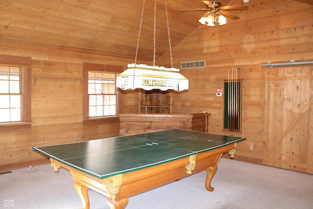 playroom with carpet floors, wood walls, visible vents, and vaulted ceiling