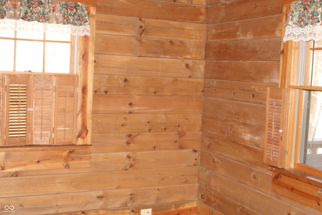 spare room featuring wood walls