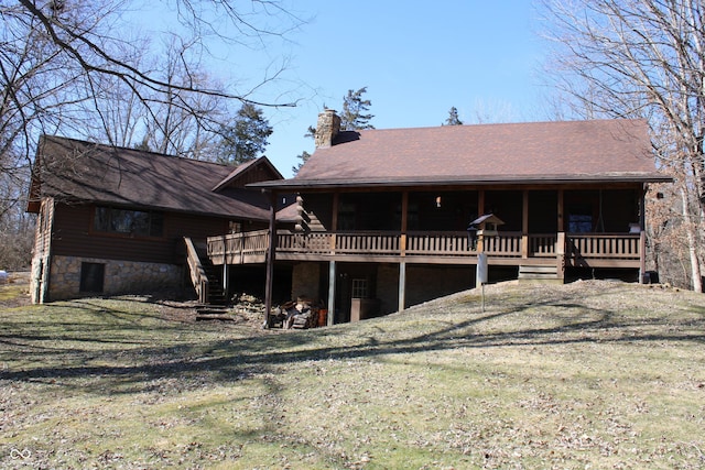 rear view of property featuring stairway, a yard, a chimney, and a wooden deck