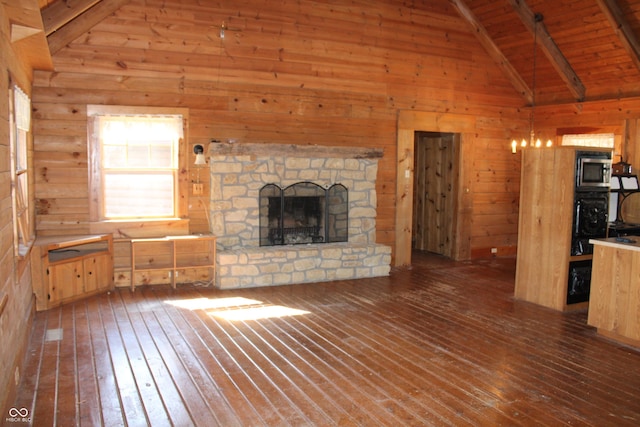 unfurnished living room with wooden ceiling, hardwood / wood-style flooring, wooden walls, and a fireplace