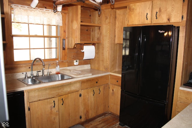 kitchen featuring light countertops, a sink, black appliances, and open shelves