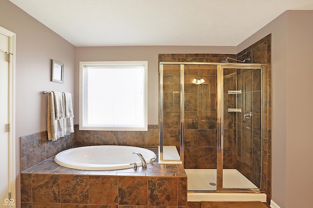 full bathroom with a stall shower and a garden tub