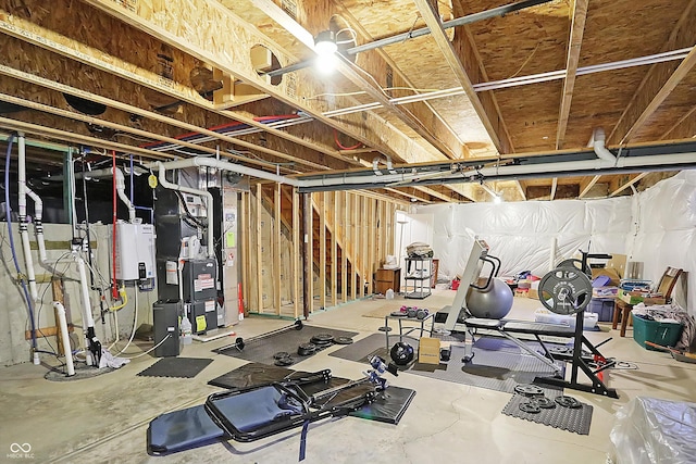 workout room featuring tankless water heater and heating unit