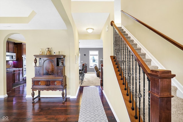 interior space featuring baseboards and wood finished floors