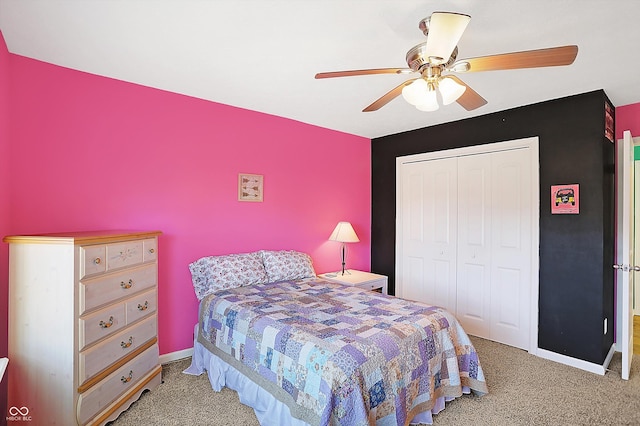 carpeted bedroom with a closet, a ceiling fan, and baseboards