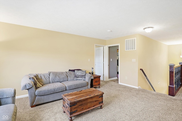 living area with carpet floors, baseboards, and visible vents