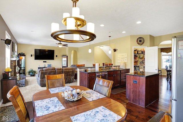 dining space with arched walkways, ceiling fan, dark wood-style floors, and recessed lighting