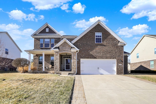 view of front of property featuring driveway, a garage, stone siding, a porch, and a front lawn