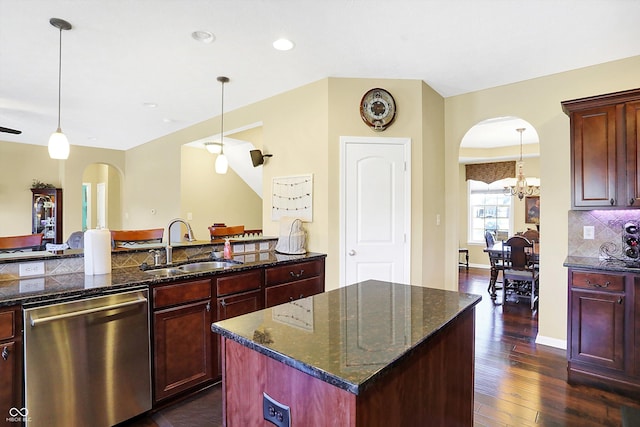 kitchen featuring arched walkways, dark brown cabinets, stainless steel dishwasher, and a sink