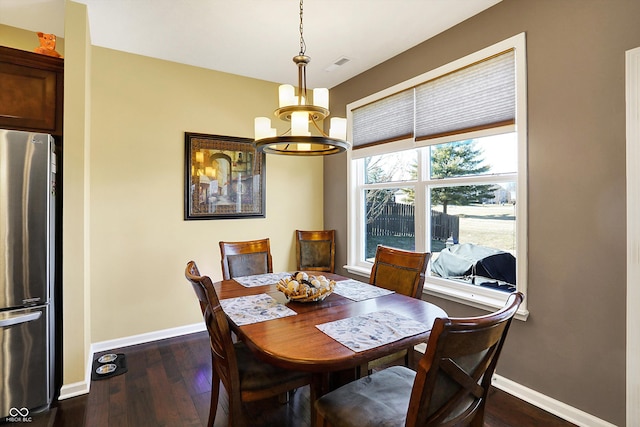 dining space featuring visible vents, baseboards, a chandelier, and dark wood-style flooring