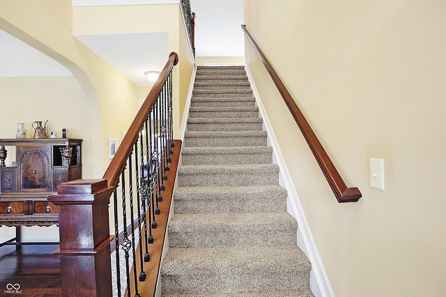 staircase featuring baseboards