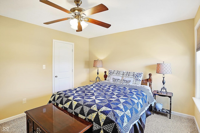 carpeted bedroom with ceiling fan and baseboards