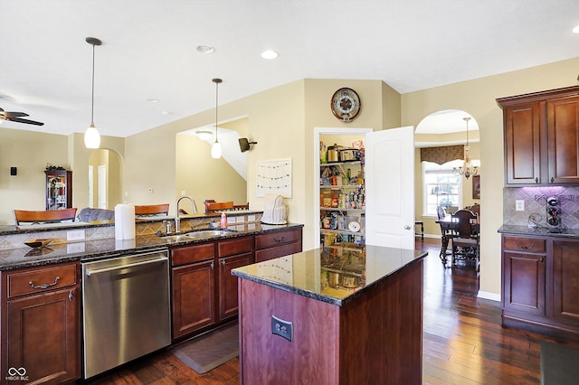 kitchen with a sink, arched walkways, dark brown cabinets, and stainless steel dishwasher