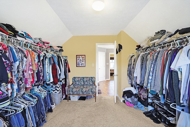 spacious closet featuring carpet floors and lofted ceiling