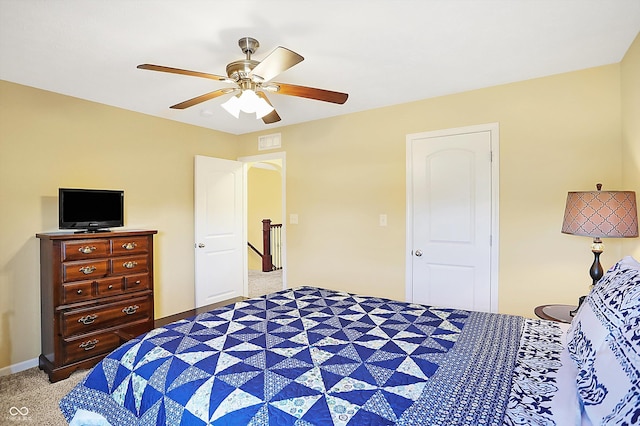 carpeted bedroom featuring ceiling fan, visible vents, and baseboards