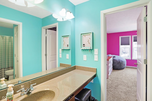 ensuite bathroom featuring toilet, vanity, and ensuite bathroom