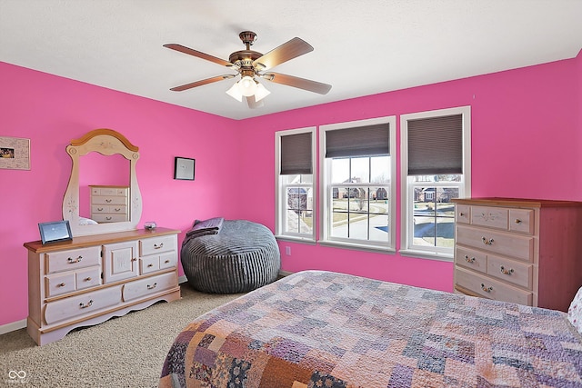 carpeted bedroom featuring ceiling fan and baseboards