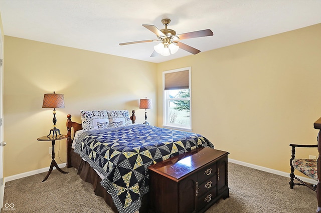 carpeted bedroom with ceiling fan and baseboards