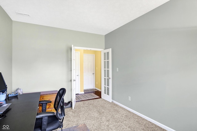 carpeted home office with french doors, visible vents, and baseboards