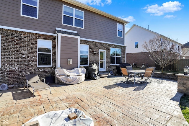 view of patio with entry steps, fence, and outdoor dining space