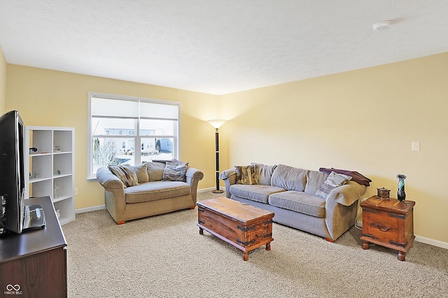 carpeted living area featuring a textured ceiling and baseboards