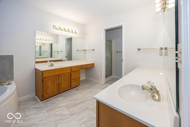 bathroom featuring marble finish floor, two vanities, a sink, and a shower stall