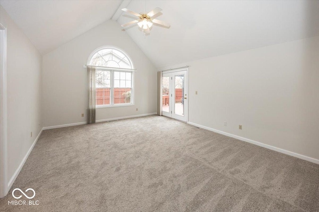 empty room featuring carpet flooring, vaulted ceiling with beams, baseboards, and ceiling fan