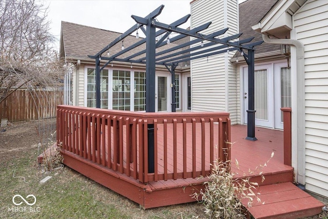 deck with fence and a pergola