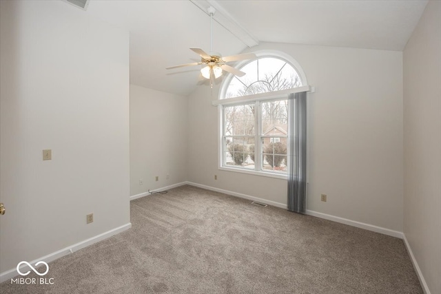 empty room with baseboards, visible vents, lofted ceiling with beams, ceiling fan, and carpet flooring