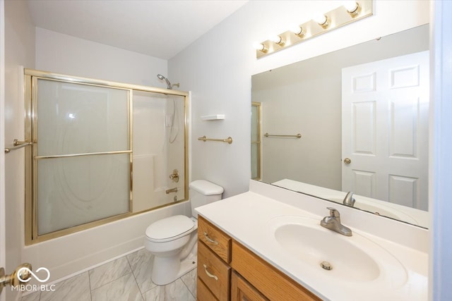 bathroom featuring marble finish floor, combined bath / shower with glass door, vanity, and toilet