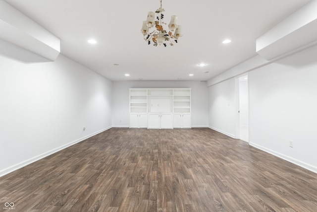 interior space featuring dark wood-type flooring, a notable chandelier, recessed lighting, and baseboards