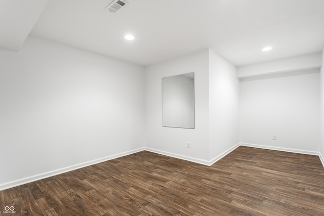 unfurnished room featuring dark wood-style floors, visible vents, recessed lighting, and baseboards