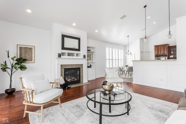 living area with dark wood finished floors, recessed lighting, a fireplace, and visible vents