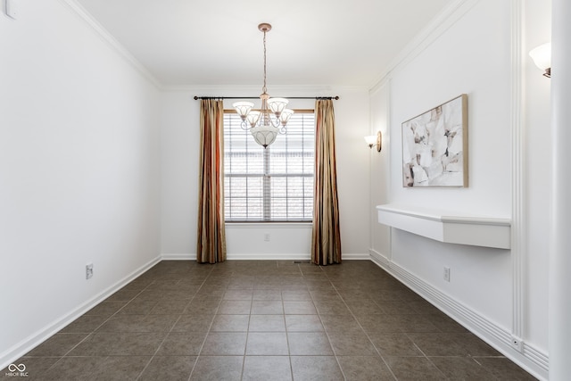 unfurnished room with a chandelier, crown molding, baseboards, and dark tile patterned flooring