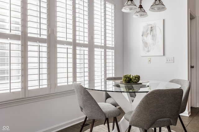 dining space featuring baseboards and a healthy amount of sunlight