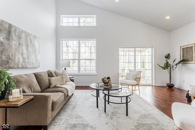 living area with recessed lighting, a healthy amount of sunlight, baseboards, and wood finished floors