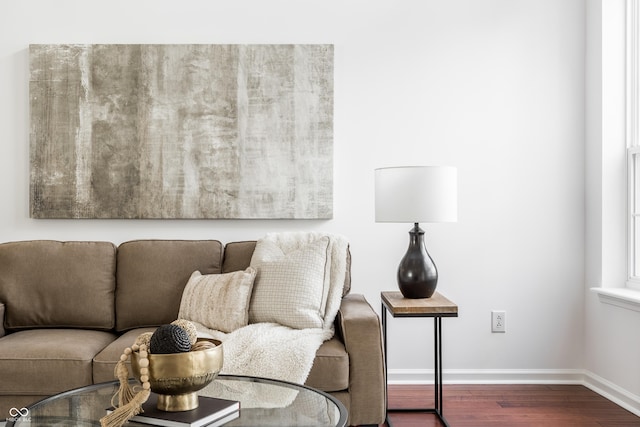 living room with baseboards and dark wood-style flooring